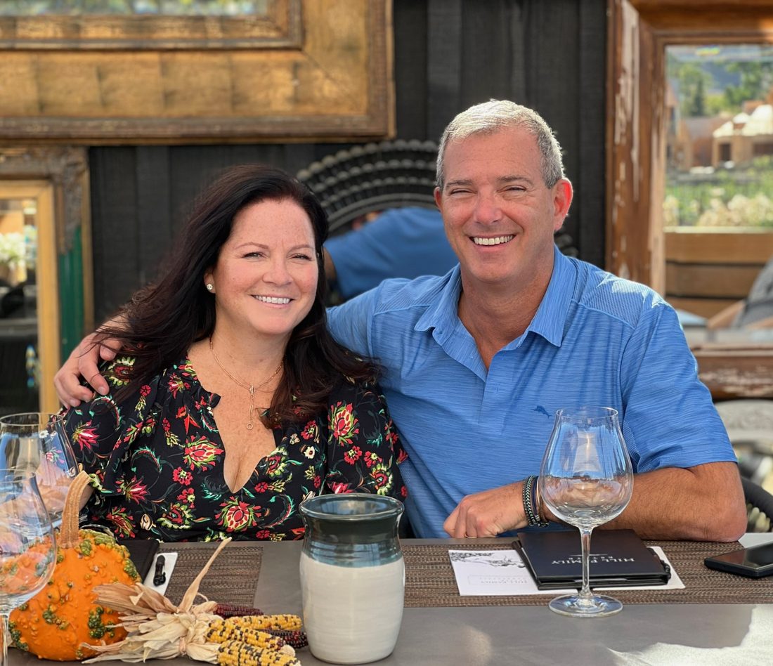 Diane and Warren smiling together at a fall wine tasting
