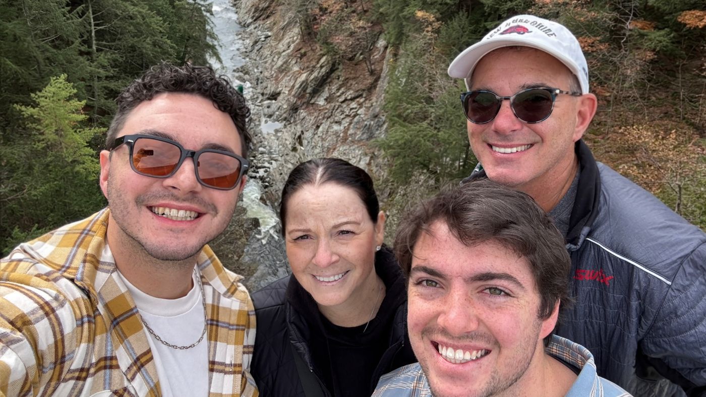 Diane with her family on a fall trip, a river gorge far below
