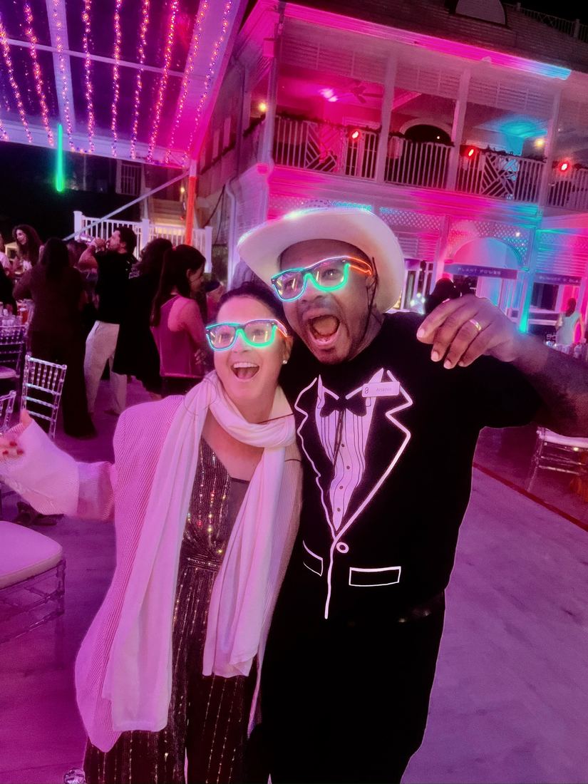Diane in glowing party glasses, dancing and celebrating