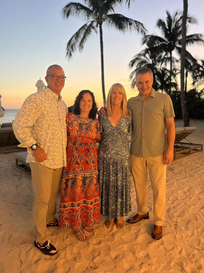 Diane with friends on the sand at sunset