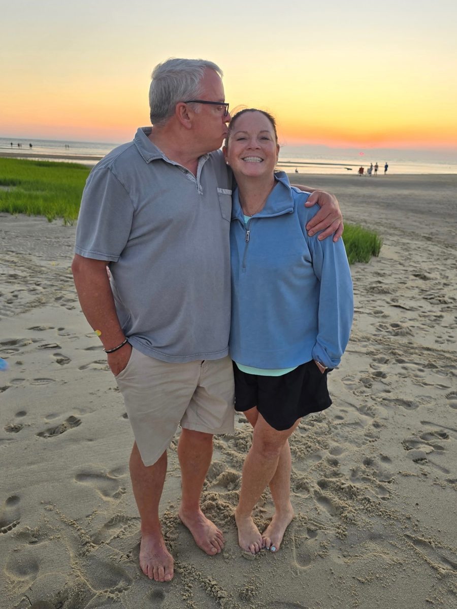Diane smiling on the beach at sunset