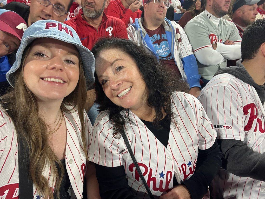Diane in a Phillies jersey at the ballpark with a friend
